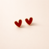 Elegant gold earrings with antique red hearts