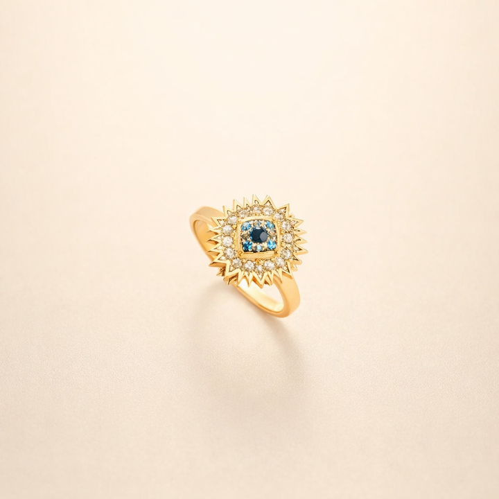Gold twist ring with sapphire and sunburst design