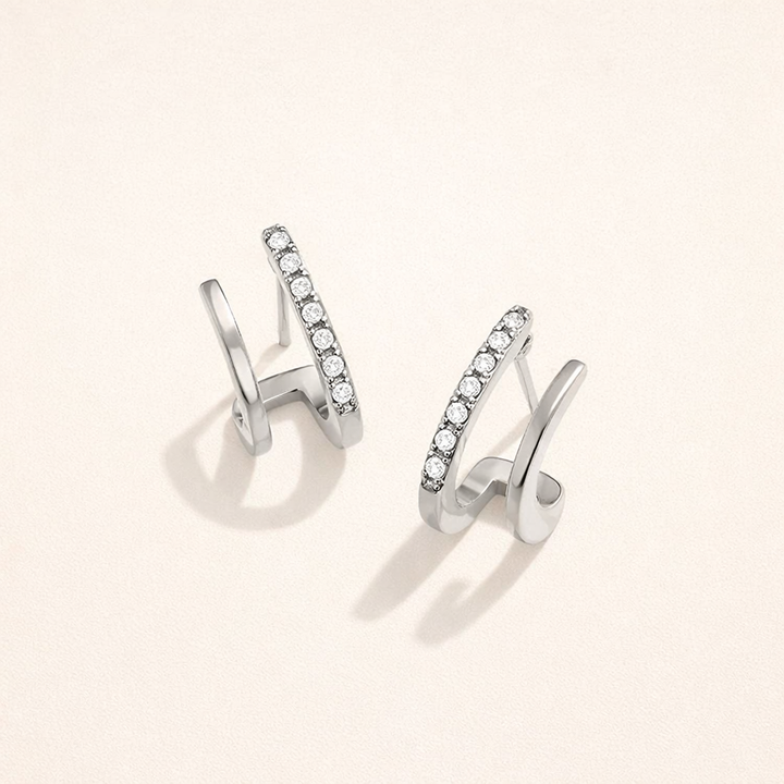 Elegant silver earrings with crystal claw design