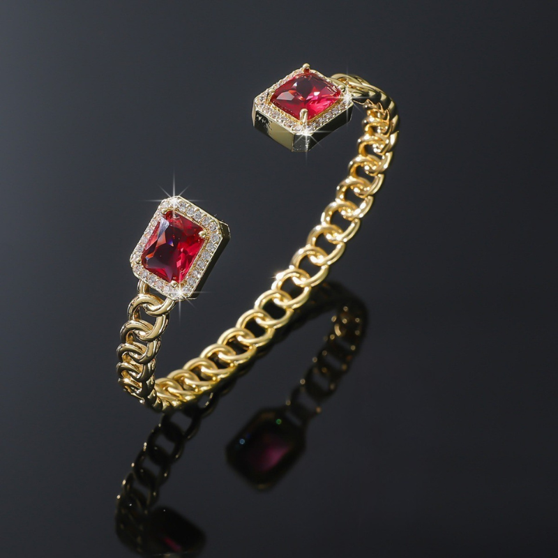 Elegant gold bracelet with a subtle ruby accent